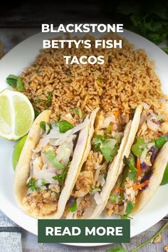 three tacos on a white plate with rice and lime wedges next to the words blackstone betty's fish tacos read more