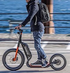 a man riding an electric scooter on the street