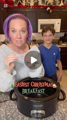 a woman with purple hair standing next to a boy in front of an electric crock pot