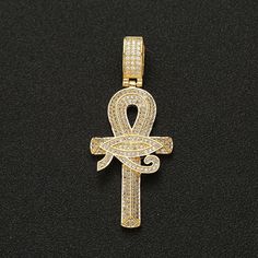 Iced Out Ankh Pendant Necklace This Iced Out Ankh Pendant Necklace is the perfect statement piece for any hip-hop, rock or fashion enthusiast. Expertly crafted with top-grade copper and meticulously paved with AAA CZ stones, its iconic ankh cross shape and 60cm link chain exude luxe, sophisticated style. Available in gold and silver, it's the ideal gift for friends, dads, husbands, boyfriends and lovers of luxury. Iced Out Pendant Jewelry For Streetwear, Iced Out Pendant For Streetwear, Gold Rope Chain Jewelry For Streetwear, Streetwear Cross Pendant Chain Jewelry, Streetwear Jewelry With Cross Pendant Chain, Gold Cubic Zirconia Necklaces For Streetwear, Gold Rope Chain Jewelry, Streetwear Jewelry: Cross Pendant Chain, Iced Out Metal Pendant Jewelry