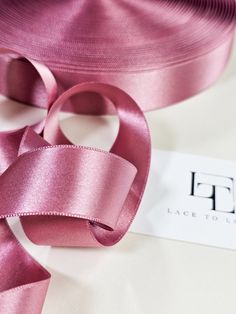 a close up of a pink satin ribbon