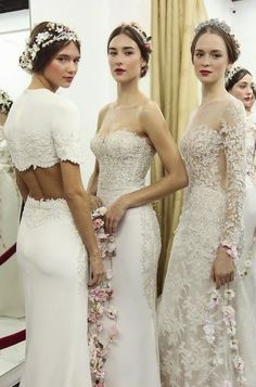 three women in white dresses standing next to each other