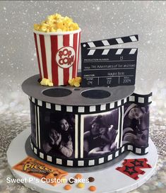 a cake made to look like a film reel with popcorn and movie tickets on top