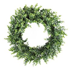 a round wreath made out of green leaves