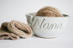 white carved yarn bowl with the name Nana holding a ball of tan yarn and a knitting project Yarn And Needles, Yarn Bowls, Yarn Holder, Painting Accessories, Nana Gifts