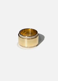 two gold rings sitting on top of each other