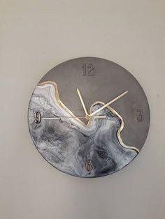 a clock that has been made to look like an abstract piece of art on the wall