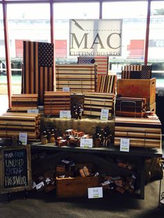 many wooden boxes stacked on top of each other in front of a sign that says mac