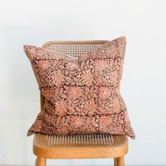 a cushion sitting on top of a wooden chair