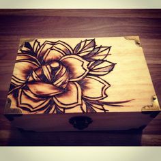 an artistically painted box sitting on top of a wooden table