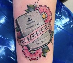 a tattoo on the arm of a woman with a memory ribbon and flowers around it