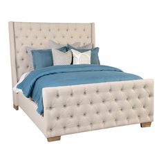 a white bed with blue sheets and pillows on the headboard, in front of a white background