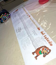 a paper with an image of a monkey hanging from it's side on a table