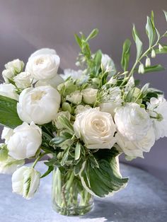 a vase filled with white flowers on top of a table