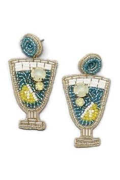 Love these new blue and white cocktail beaded earrings! There's nothing like being at the beach with a breeze sipping a cocktail and these earrings will certainly evoke that feelings. Wear these cuties for so many occasions. Just in time for Spring and Summer parties and get togethers.  Our beaded cocktail earrings are sure to make a statement and receive plenty of compliments. Made with blue, yellow, white and silver seed beads, crystals, silver accents and white and silver bugle beads.  The beading is on a beige felt backing so the earrings are soft and lightweight. The cocktails dangle from blue and silver beaded post earrings. How cute would the earrings look with one of our caps and leggings.  Our blue cocktail earrings are just adorable and perfect for the Spring and Summer! Add to y Blue And White Cocktail, Beach Beads, Beach Jewellery, Diy Fabric Jewellery, Vacation Jewelry, Diy Bead Embroidery, Cocktail Earrings, Earrings Beach, White Cocktail