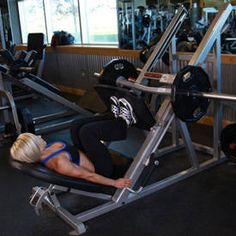 a woman laying on top of a bench in a gym