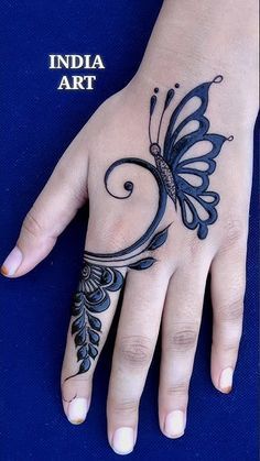 a woman's hand with a butterfly tattoo on it