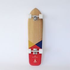 a wooden skateboard with different colors and shapes