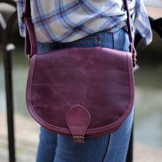 Small Isabelle Purple Leather Bag with Cross body Strap, Adjustable Classic Saddle Bag Vintage Style, Saddle purse purple, Fully adjustable long strap convertible to shoulder, Handy front pocket under flap, Strap is attached around bottom for extra strength, 70's style small saddle bag Our Purple Isabelle saddle bag is a perfectly made saddle-bag based on a real 70's pattern with pocket under flap.  The front pocket is very useful and helps to keep your items separate and secure.  The lining is waterproof with a built-in pocket.  The Isabelle bag is 7cms deep, 21cms wide, 18 in length, and the handle extends to 135cms and is 3cms thick. Purple Crossbody Shoulder Bag With Cell Phone Pocket, Purple Leather Shoulder Bag With Adjustable Strap, Purple Crossbody Bag With Adjustable Strap, Purple Satchel Shoulder Bag With Mobile Phone Bag, Purple Satchel Shoulder Bag With Mobile Phone Pocket, Everyday Purple Shoulder Bag With Cell Phone Pocket, Purple Crossbody Bag For Everyday Use, Purple Everyday Crossbody Shoulder Bag, Purple Shoulder Bag With Detachable Strap For Everyday