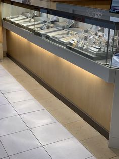 a display case filled with lots of different types of silverware on top of a counter