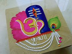 a colorful cake with the number thirty five on it's side, decorated with pearls and beads