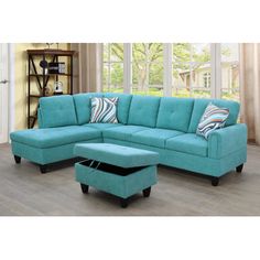 a living room with a blue couch and ottoman