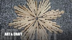 a group of wooden sticks sitting on top of a black table next to silver glitter