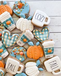 decorated cookies with the words fall written on them and coffee mugs, tea cups, and hearts