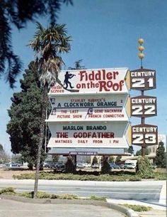 a sign for fiddler on the roof in front of a building with palm trees