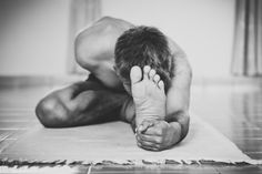 a man is doing yoga on the floor