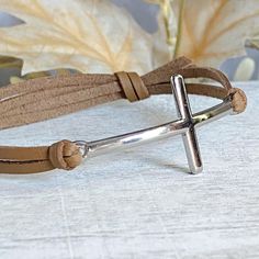 Sideways Cross Leather bracelet, a great confirmation, first communion or baptism gift for just about anyone. Cross size - 2" x 3/4" PERSONALIZATION AND PACKAGING  *Each piece is custom made to your specifications upon receipt of order. *All our jewelry and gifts are packaged in a complimentary gift box. *A personal note will be included upon request  HOW TO PLACE YOUR ORDER  Step 1 - select leather color Step 2 - select size Step 3 - select number of items you wish to purchase  CHECKOUT  PROCESSING TIMES  All orders are currently being processed and shipped within 3 business days - If you need it sooner you may choose expedited shipping at checkout. TRANSIT TIMES  Typically transit times are 2-5 business days anywhere in the US. International transit times are typically 7-14 business days Leather Bracelet Women, Leather Bracelet Men, Leather Bracelets Women, Bracelet Men, Bracelet Leather, Bracelet Women, Mens Leather Bracelet, Cross Bracelet, Leather Cross