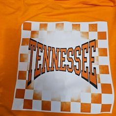 an orange tennessee t - shirt with the word tennessee on it and checkered background