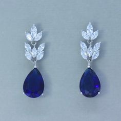 "Sapphire blue crystal earrings will beautifully fill your order of 'something blue' for you or your girls. Designed with marquise shaped crystals in a segmented style for lovely movement and create such sparkle! We finished them with a beautiful teardrop for a great mid-length earring. 'Sandra' will have all eyes on you. Why not treat yourself or your bridesmaids, or both! ❣ Earring length is 1.5\". ❣ Highest-quality cubic zircons set in tarnish-resistant 18K rhodium for heirloom quality. ❣ Nic Formal Blue Crystal Earrings, Blue Sapphire Pear-shaped Earrings, Blue Pear-shaped Party Earrings, Blue Dangle Crystal Earrings For Formal Occasions, Blue Teardrop Crystal Earrings For Wedding, Elegant Blue Crystal Teardrop Earrings, Elegant Blue Drop Crystal Earrings, Blue Drop Bridal Earrings For Formal Events, Blue Drop Bridal Earrings For Formal Occasions