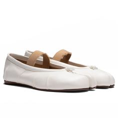 The Tabi Elastic Band Mule in Ivory/Nude, made from lamb leather, features the distinctive Tabi split-toe design and an elastic band for a comfortable fit. These mules are crafted with attention to detail, including handmade folds and subtle branding with the Maison Margiela logo on the sole. Made in Italy, they are a blend of traditional style and modern craftsmanship. 100% Lamb leather upper, lining, and interior 100% Calf leather sole Distressed elastic band, Tabi split toe Handmade leather f Cream Leather Closed Toe Ballet Flats, Cream Ballet Flats With Leather Sole, White Leather Ballet Flats With Round Toe, Cream Ballet Flats With Removable Insole And Almond Toe, Classic Cream Leather Ballet Flats, White Leather Ballet Flats With Rubber Sole, Cream Leather Slip-on Ballet Flats, Beige Leather Ballet Flats Medium Width, Cream Slip-on Flats With Removable Insole