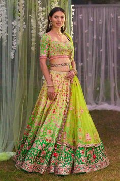 Green thread and gota embroidered on shaded silk lehenga in floral pattern. Paired with embroidered belt, blouse and embroidered net dupatta.
Component: 4
Pattern: Embroidered
Type Of Work: Gota and Thread
Neckline: Sweetheart
Sleeve Type: Tassel
Fabric: Silk, Dupatta: Net
Color: Green
Other Details: 
Back tassel tie-up
Embroidered belt
Length (in inch):
Lehenga: 43
Blouse: 14
Occasion: Bride,Wedding - Aza Fashions Green Lehenga With Floral Embroidery For Navratri, Wedding Sets In Art Silk With Floral Embroidery, Transitional Multicolor Embroidered Fabric For Wedding, Green Anarkali Set With Floral Embroidery For Wedding, Green Embroidered Lehenga For Wedding, Green Embroidered Fabric For Wedding And Navratri, Wedding Saree Set With Multicolor Embroidery, Semi-stitched Pista Green Lehenga With Floral Embroidery, Embroidered Kundan Sets For Wedding