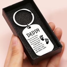 a hand holding a keychain that says, daddy you are the best dad