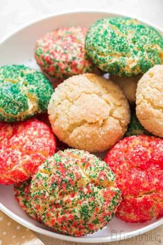 a white bowl filled with cookies covered in sprinkles on top of a table