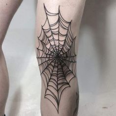 a spider web tattoo on the leg