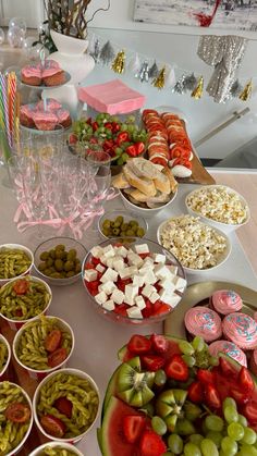 a table filled with lots of different types of food and desserts on top of it