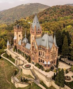 an aerial view of a castle in the mountains