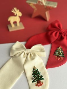 three ties with christmas trees on them are sitting next to each other and one has a bow