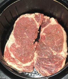 steaks cooking in a frying pan on the stove