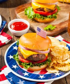 an american flag plate with a hamburger and chips on it, along with two dipping sauces