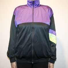 "Vintage women`s 80s shelljacket. Windbreaker Size large. Unisex purple, neon green, yellow green and black colors tracksuit jacket. Old school sportswear. Sport Windbreaker with zipper closure. Sport Hipster Jacket.  Full front zipper. 2 zippered hand pockets.  no labeled size, but estimated women`s size is L. The women`s model has M size (at the photos). 175 cm / 68.3\" inches tall women. no labeled materials. Measures in lying flat: Chest width armpit to armpit: 53 cm / 20.7\" in Length: 67 cm / 26.1\" in Sleeve length ( from shoulder seam to sleeve end ): 58 cm / 22.6\" in Shoulders width: 55 cm / 21.5\" in Normal vintage condition, used. #in131" Sporty Purple Track Jacket For Streetwear, Purple Track Jacket For Fall Streetwear, Sporty Stretch Track Jacket For Streetwear, Casual Purple Track Jacket For Sports, Sporty Purple Track Jacket For Fall, Purple Fall Windbreaker For Sports, Sporty Purple Windbreaker For Fall, Purple Fall Sports Windbreaker, 90s Style Purple Sports Outerwear