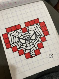 a drawing of a spider web in red and black squares on white paper with writing underneath it