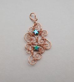 "I created this elegant and detailed pendant by hand-forming swirls of untreated copper wire, hammering the wire to flatten, strengthen, and texture it, and attaching the swirls together with wire wraps into a complex pattern surrounding a pair of rainbow hematite stars. The bail to hang the pendant from a chain is hand-formed from wire in the same way. The pendant is approximately 2 3/4\" long including the bail, and approximately 1 3/8\" across at the widest point.  It is extremely lightweight.  No two spiral filigree pieces will ever be quite the same -- the sizes and shapes of the spiraled wires are different every time, as are the way they fit together.  The wire in this piece is untreated copper, which will naturally tarnish and darken with time, or can be polished brighter again wit Rainbow Hematite, Unique Statement Necklace, Rainbow Stars, Wrapped Necklace, Snake Jewelry, Rainbow Star, Snake Necklace, Filigree Pendant, Silver Snake Chain