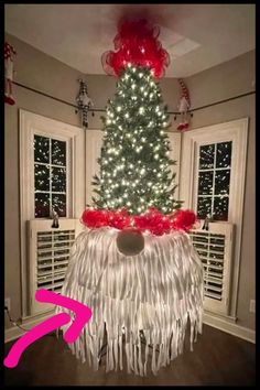 a christmas tree decorated with lights and fringes