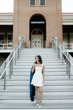 a woman standing on steps in front of a building