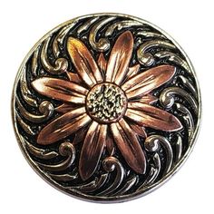 a metal button with a flower on it