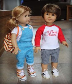 two dolls are standing next to each other